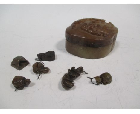 A Chinese jade quatrefoil box with small tortoise charms inside  