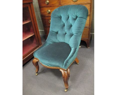 A Victorian rosewood button back nursing chair on cabriole legs  
