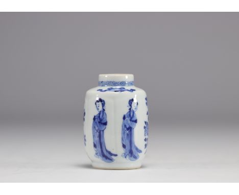 A small white and blue vase decorated with flowers and women in traditional dress from the Kangxi period (1661-1722) with a m