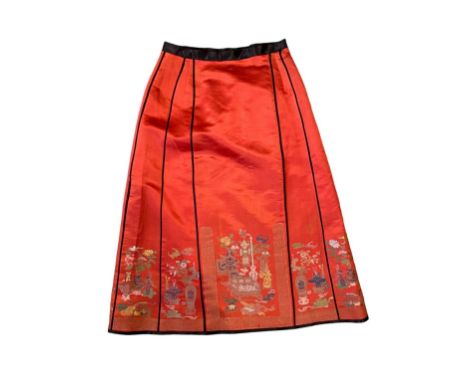 Chinese skirt in red silk decorated with polychrome and gold thread embroidery of vases, perfume burners, flowers and bats. -