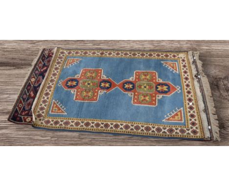 Two thick hand knotted mid 20th Century Persian rugs, central regions, deep reds and light blue ground, 208cm x 120cm - 174cm