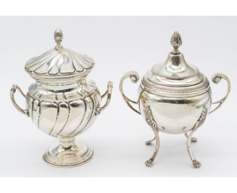 A Continental silver twin handled urn and cover, on four curved legs leading to paw feet, ornate curved handles connected fro