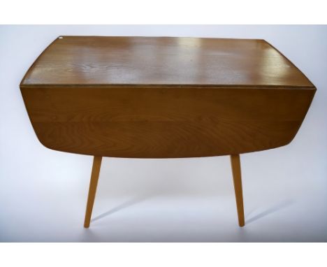 A mid 20th Century Ercol light oak dropleaf kitchen/dining table.
