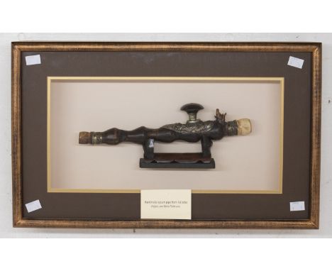 A late 19th century handmade opium pipe from the hill tribe region, northern Vietnam, within a glazed modern display case, th