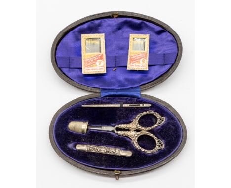 A cased late Victorian silver sewing set consisting of threading needle, scissors, thimble and needle case, hallmarked by Lev