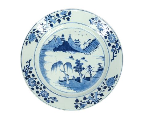 A late Kangxi 18th century Chinese blue and white charger, with chinoiserie and floral design, approx. 35cm diameter.  Condit
