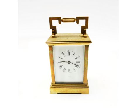 A French brass cased carriage clock with stylised carry handle and roman numeral dial, signed Vokes, Paris. With key, Unteste
