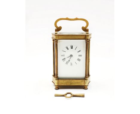 An ornate French brass cased carriage clock, on four circular feet, roman numeral dial, marked Made In France to back, swirl 