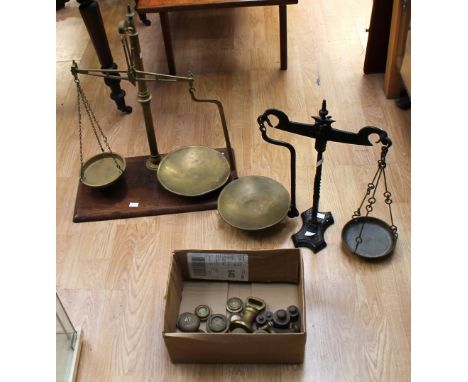 Two late 19th Century table scales on stands with weights, one on mahogany stand other cast iron.