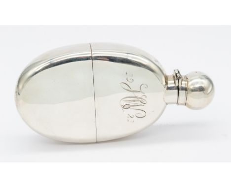 A late Victorian silver hip flask, oval shape with hinged top, removable silver cup, body engraved "JW, 1921", hallmarked by 