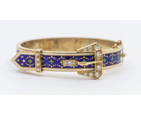 A diamond and enamel 14ct gold buckle bangle, comprising blue guilloche enamel ground overlaid with gilt and green enamel mot