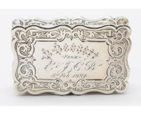 A Victorian silver snuff box, of scrolled form, ornate chasing and engraving to all sides, engraved "B. Bennett from E & SCB,