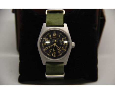 A gent's US Navy mechanical wristwatch.