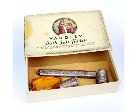 A hallmarked silver covered pencil with two silver thimbles (one by Charles Horner) with an amber pendant and chain.