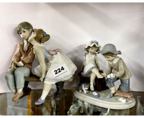 A Lladro 1995 10th anniversary figure of two children on a bench, H. 19cm. Together with a further Lladro figure.