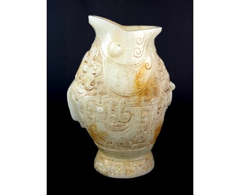 A Chinese carved jade archaic form fish shaped vase, H. 25cm.