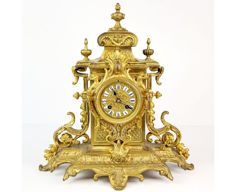 A 19th C. gilt brass mantle clock with porcelain numerals, H. 39cm.