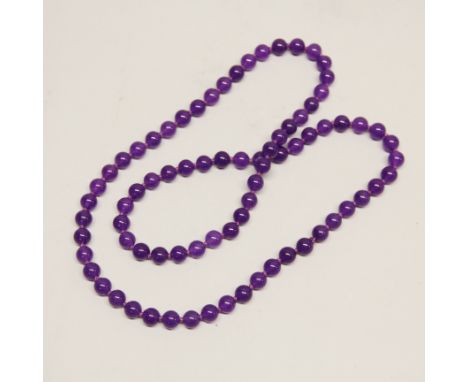A single strand necklace of lavender jade beads, bead size 8mm. Necklace L. 66cm.