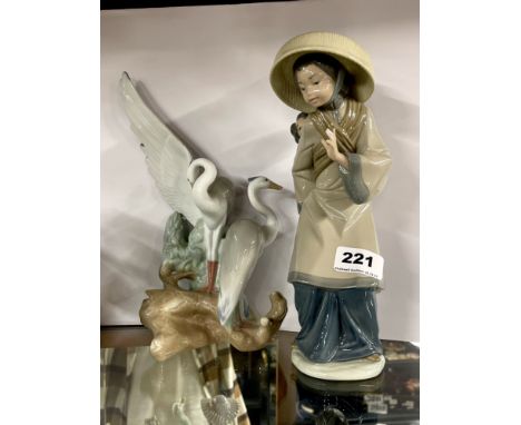 A Lladro figure of a Vietnamese girl with a child on her back, H. 27cm. Together with a Nao figure of cranes.