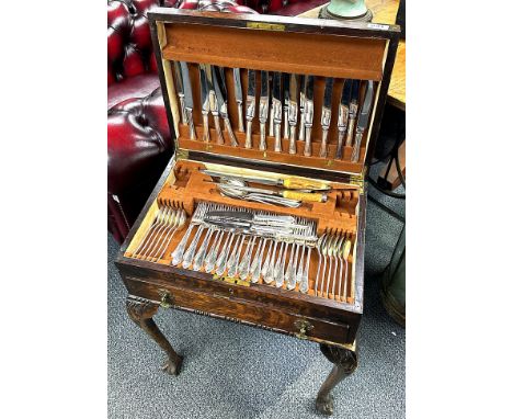 An oak cabinet cased silver plated cutlery set by Mappin and Webb.