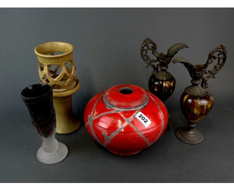 A studio pottery lamp base, a pair of pottery and metal jugs and a carved glass vase. Lamp base Dia 24cm.