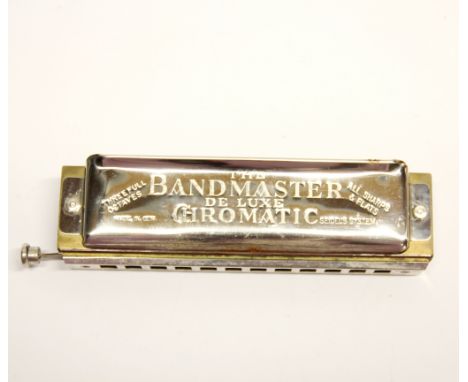 A Bandmaster chromatic harmonica.