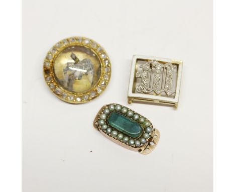 A yellow metal diamond set clasp with a yellow metal diamond set intial M and a rose metal jade and seed pearl clasp. Largest
