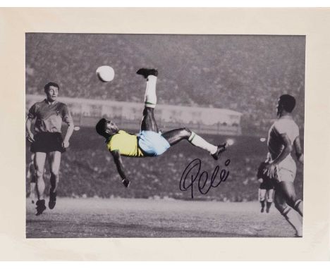 A BLACK &amp; WHITE PHOTOGRAPHIC PRINT of Pelé playing for Brazil, the print being colour enhanced in a spectacular 'Almost g