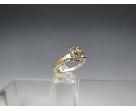 AN 18CT WHITE GOLD FOUR STONE DIAMOND RING, the princess cut stones set in a square, total diamond weight approx. 0.75 cts