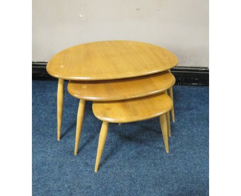 AN ERCOL LIGHT ELM 'PEBBLES'  NEST OF THREE TABLES