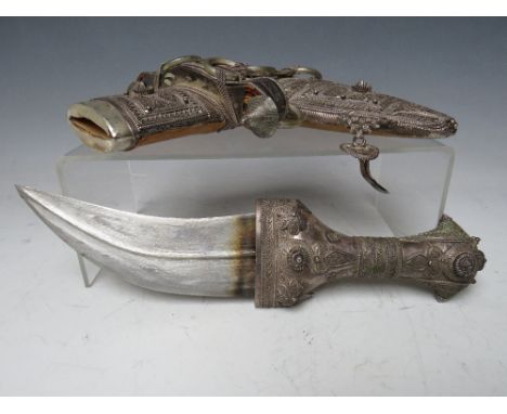 A VINTAGE MIDDLE EASTERN JAMBYA DAGGER, with white metal handled accoutrements and leather covered scabbard, blade L 16 cm, o