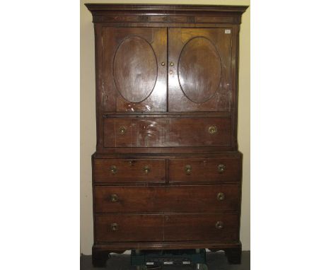 Early 19th Century Welsh oak press cupboard having moulded cornice and shell inlay. Two blind panelled doors above an arrange