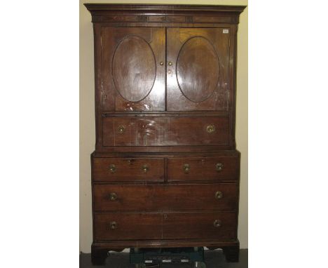 Early 19th Century Welsh oak press cupboard having moulded cornice and shell inlay. Two blind panelled doors above an arrange