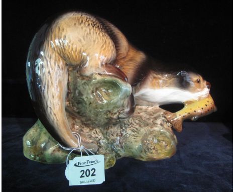 Sylvac ceramic study of an otter with its catch on naturalistic base, impressed and printed marks to the base, shape no. 3459