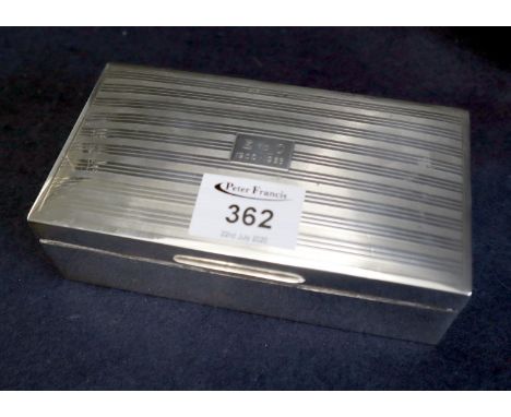 Silver engine turned rectangular cigarette box with hinged cover and wood lining. Birmingham hallmarks 1928 with makers initi