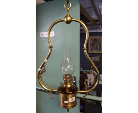 Early 20th Century single oil burner hanging light, having brass mounts and amber reservoir. (B.P. 24% incl. VAT) 