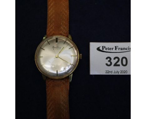 Bentina star gold plated gentleman's wristwatch with satin face having baton numerals and sweep second hand on fabric strap.(