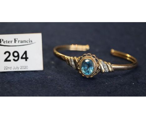 A 9ct gold blue topaz and diamond bangle, 9.6g approx weight. (B.P. 24% incl. VAT) 