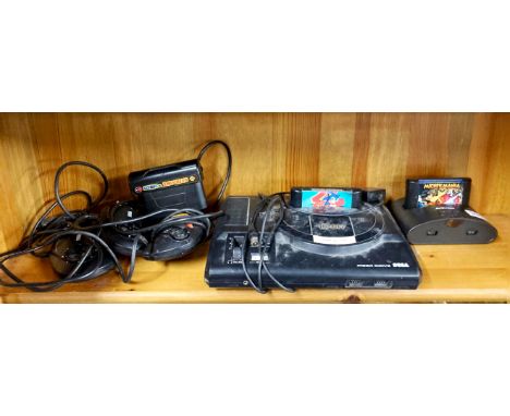 A vintage Sega Megadrive games console and related items.