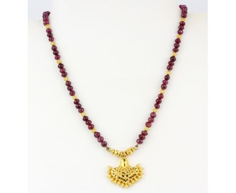 A 22ct yellow gold (tested high carat gold, approx. 22ct) and ruby bead necklace, L. 40.5cm.