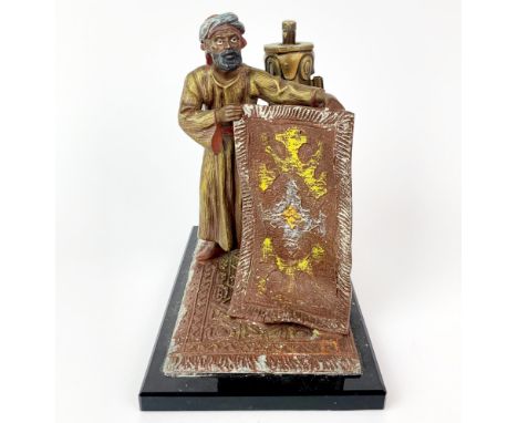 A 1920's/30's Vienna style cold painted metal strike lighter of an Arab carpet seller, H. 14.5cm.