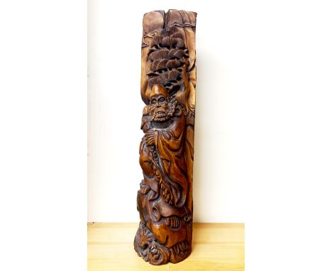 A Chinese carved hardwood tree trunk, depicting a sage, H. 67cm, W. 17cm.