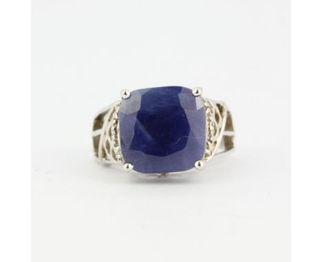 A 925 silver ring set with a large cushion cut blue sapphire and white topaz, sapphire size 1.2 x 1.2cm, (O). With certificat