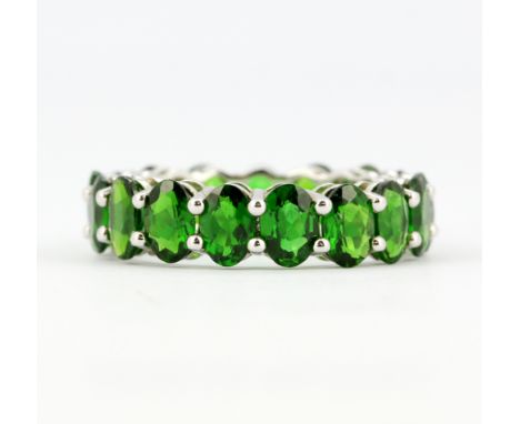 A 925 silver full eternity ring set with oval cut chrome diopside, approx. 8.14ct total, (O). With certificate.