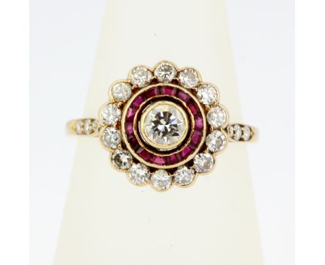A yellow metal (tested 18ct gold) cluster ring set with diamonds, rubies and diamond set shoulders, (N).