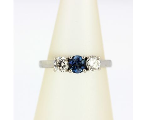 A 950 platinum ring set with a blue stone flanked by brilliant cut diamonds, approx. 0.5ct diamonds, (K).