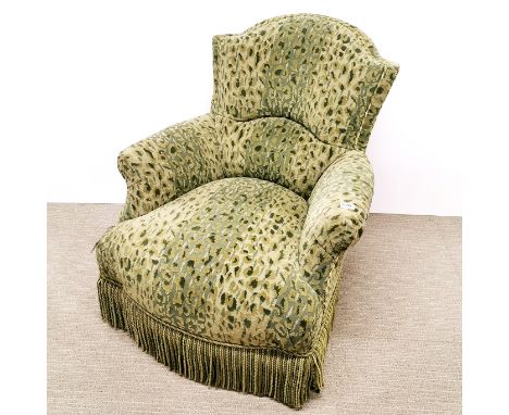 A green leopard print upholstered armchair with tassel border, H. 83cm.