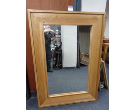 A contemporary light oak mirror. 