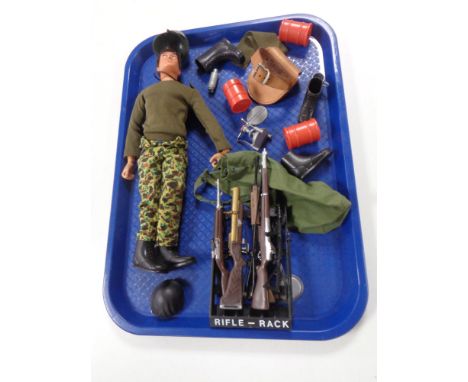 A vintage action man together with accessories including rifle rack, machine gun, clothing etc 