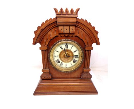 A late Victorian walnut mantel clock. 